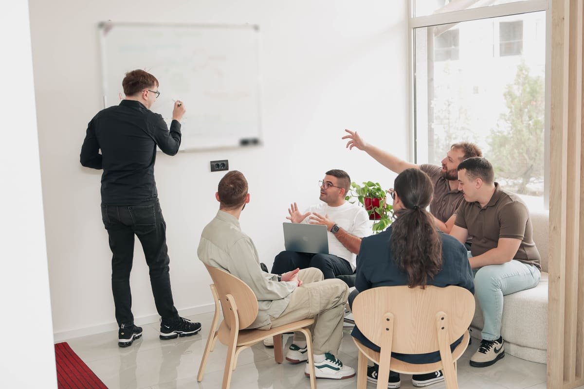 TekPiq engineers in an architecture session at the whiteboard, one of them sketching the data model